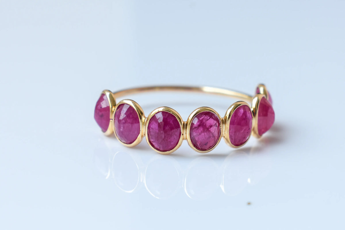 Oval-cut ruby single-row eternity ring in 14K gold
