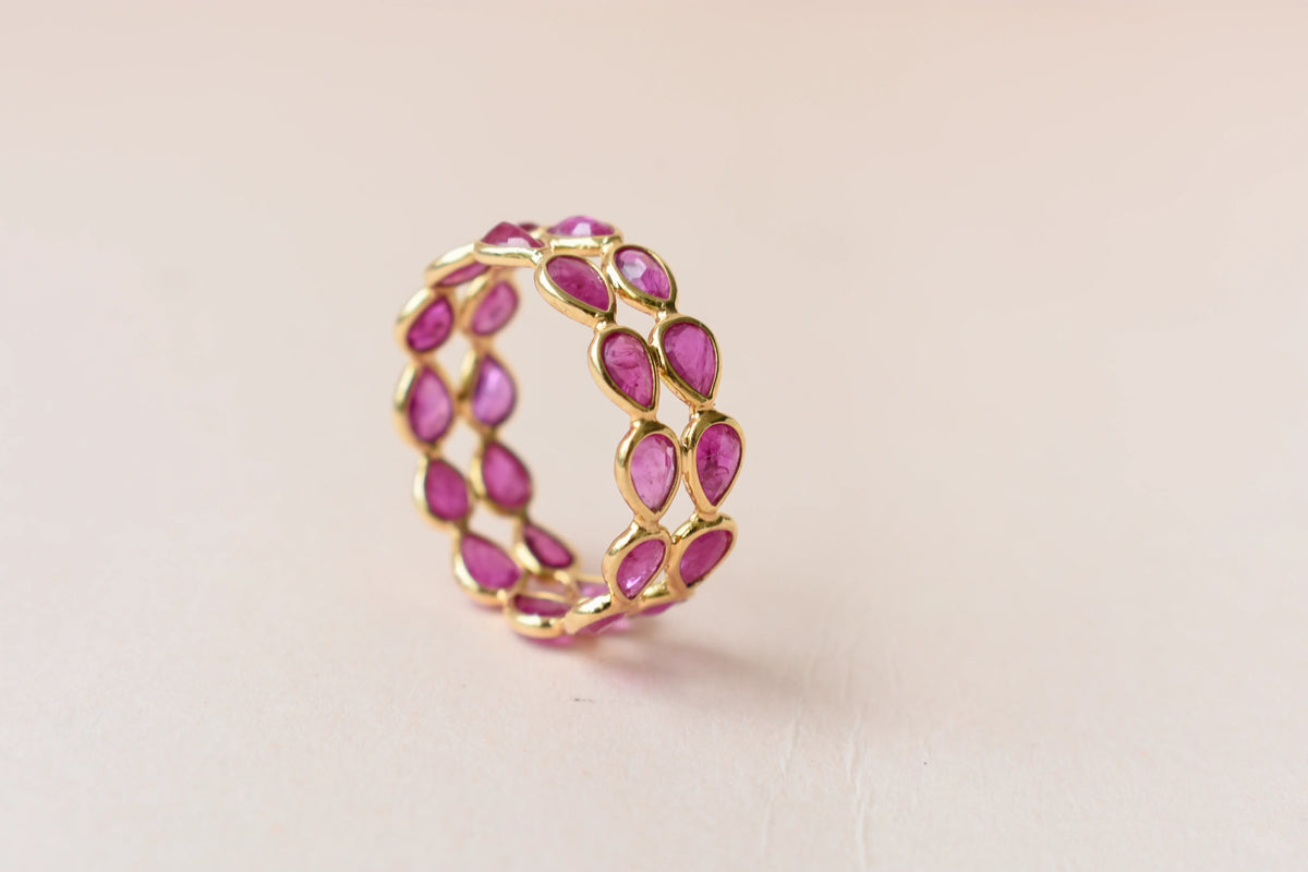 Pear-cut ruby woven double-row eternity ring in 18K gold