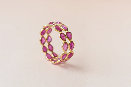 Pear-cut ruby woven double-row eternity ring in 18K gold