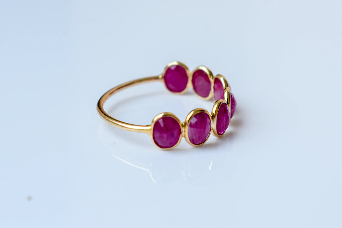 Oval-cut ruby single-row eternity ring in 14K gold