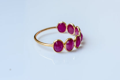Oval-cut ruby single-row eternity ring in 14K gold