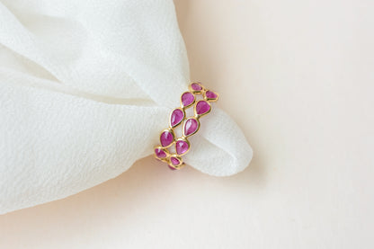 Pear-cut ruby woven double-row eternity ring in 18K gold