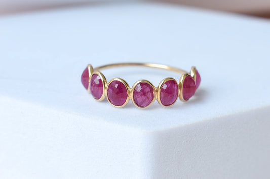 Oval-cut ruby single-row eternity ring in 14K gold