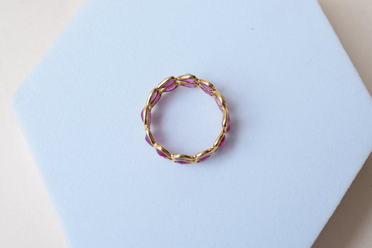 Pear-cut ruby woven double-row eternity ring in 18K gold