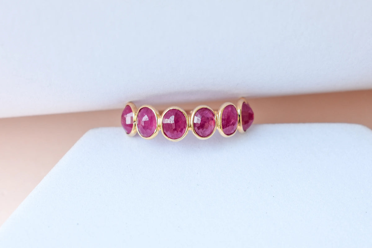 Oval-cut ruby single-row eternity ring in 14K gold
