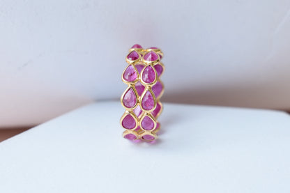 Pear-cut ruby woven double-row eternity ring in 18K gold