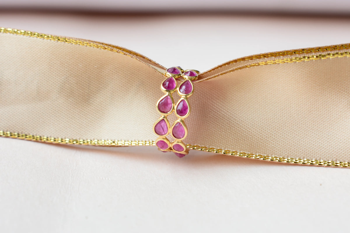 Pear-cut ruby woven double-row eternity ring in 18K gold