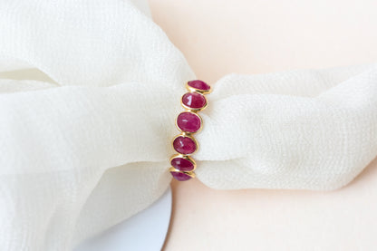Oval-cut ruby single-row eternity ring in 14K gold