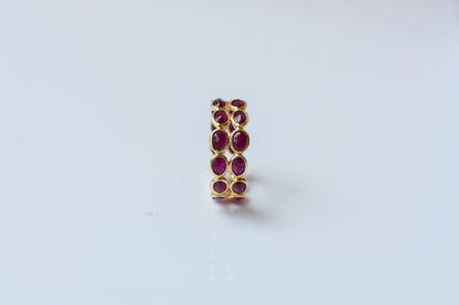 Oval-cut ruby honeycomb double-row eternity ring in 18K gold