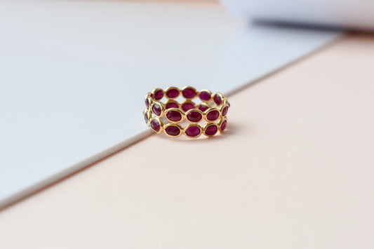 Oval-cut ruby honeycomb double-row eternity ring in 18K gold