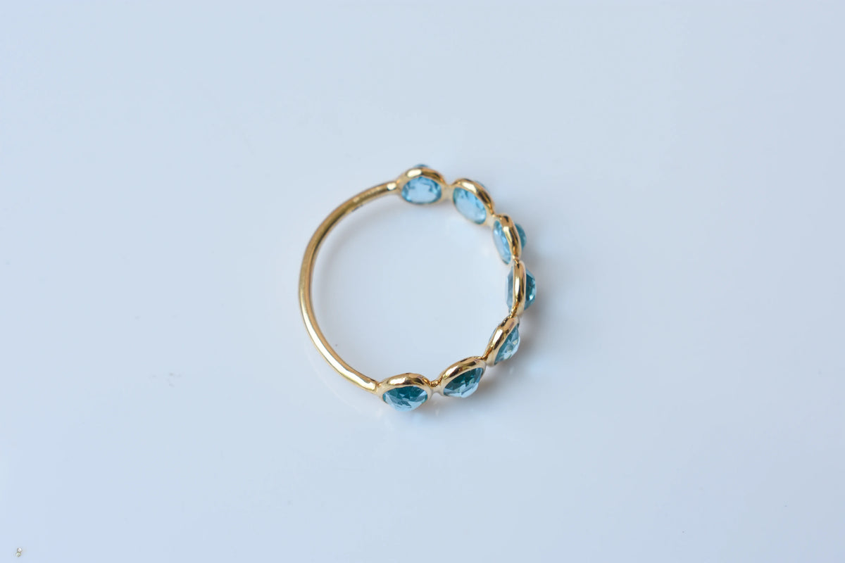 Oval-cut Swiss blue topaz single-row eternity ring in 14K gold