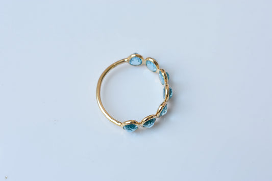 Oval-cut Swiss blue topaz single-row eternity ring in 14K gold