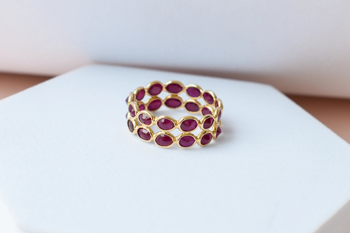 Oval-cut ruby honeycomb double-row eternity ring in 18K gold