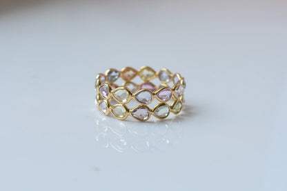 Pear-cut pastel multicolor sapphire eternity ring in 18K gold