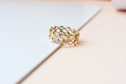 Pear-cut pastel multicolor sapphire eternity ring in 18K gold