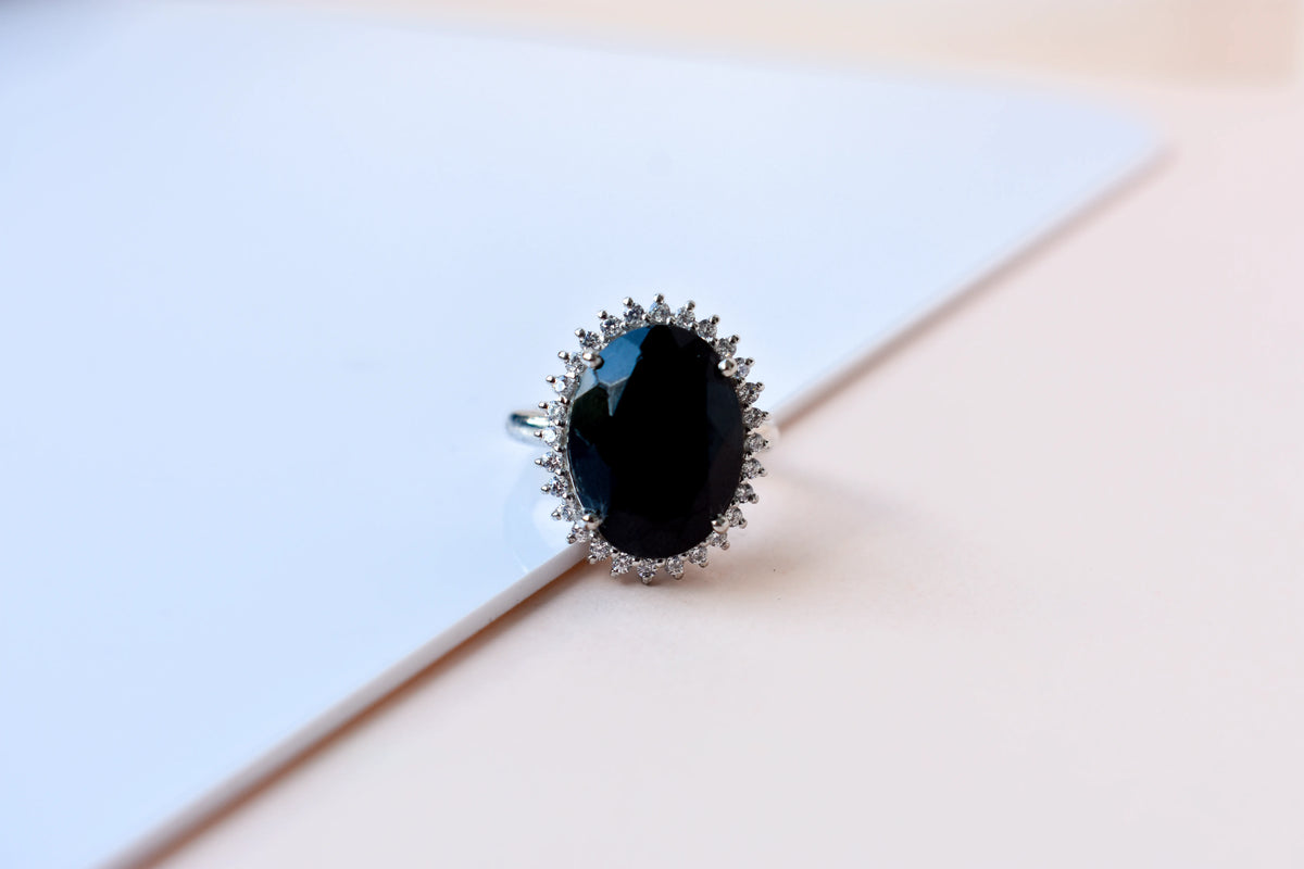 Oval black onyx halo ring in 925 silver with white cubic zirconia border
