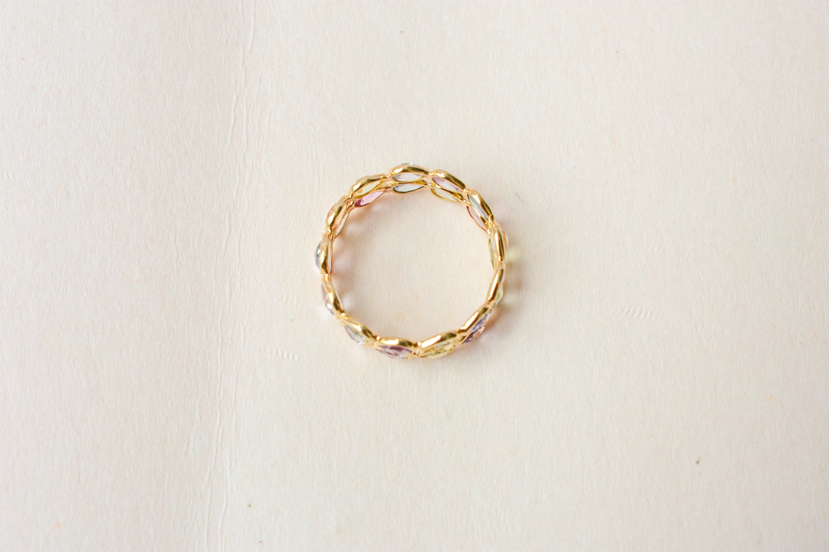 Pear-cut pastel multicolor sapphire eternity ring in 18K gold
