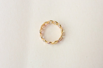Pear-cut pastel multicolor sapphire eternity ring in 18K gold