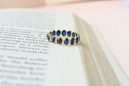 Oval cabochon blue sapphire eternity ring in 18K gold
