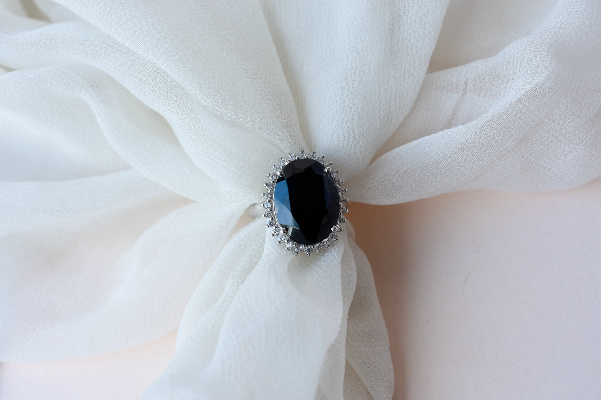 Oval black onyx halo ring in 925 silver with white cubic zirconia border
