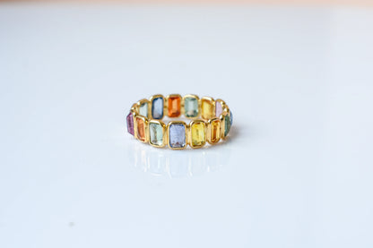 Emerald-cut multicolor sapphire eternity ring in 18K gold