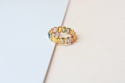 Emerald-cut multicolor sapphire eternity ring in 18K gold