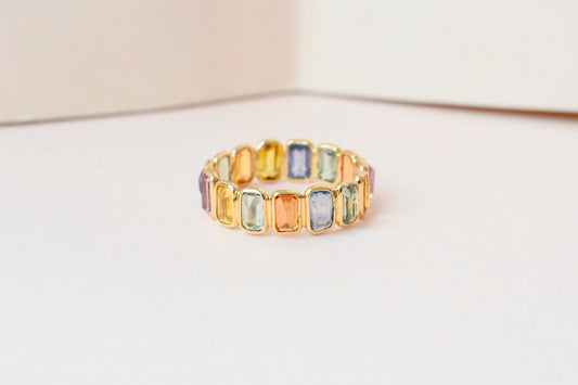 Emerald-cut multicolor sapphire eternity ring in 18K gold