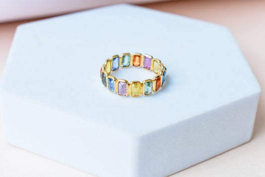 Emerald-cut multicolor sapphire eternity ring in 18K gold