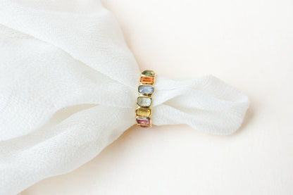 Emerald-cut multicolor sapphire eternity ring in 18K gold
