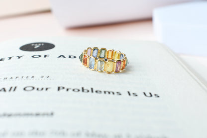 Emerald-cut multicolor sapphire eternity ring in 18K gold