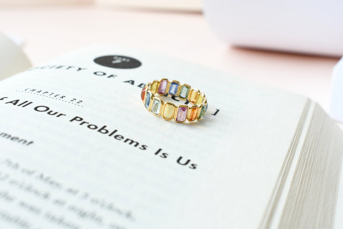 Emerald-cut multicolor sapphire eternity ring in 18K gold