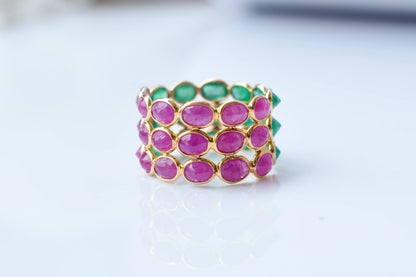 Two-tone emerald and ruby eternity ring in 18K gold
