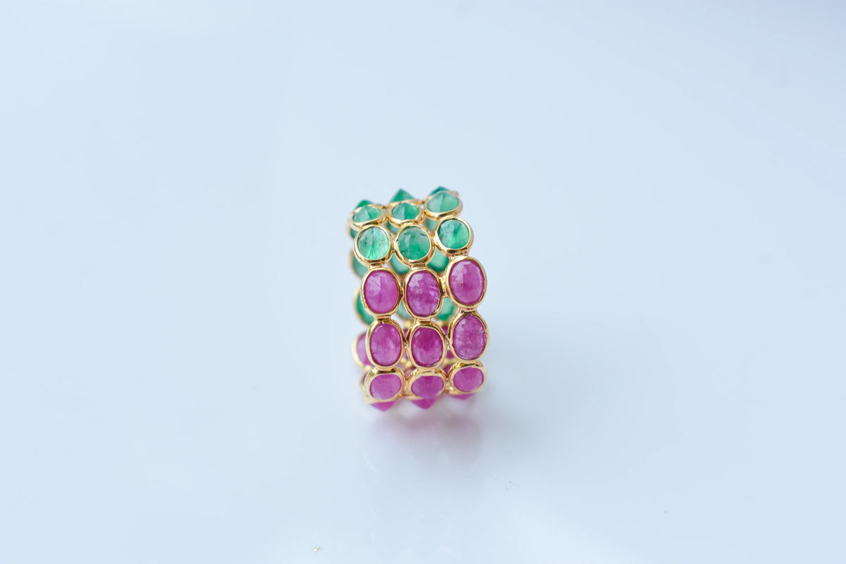 Two-tone emerald and ruby eternity ring in 18K gold