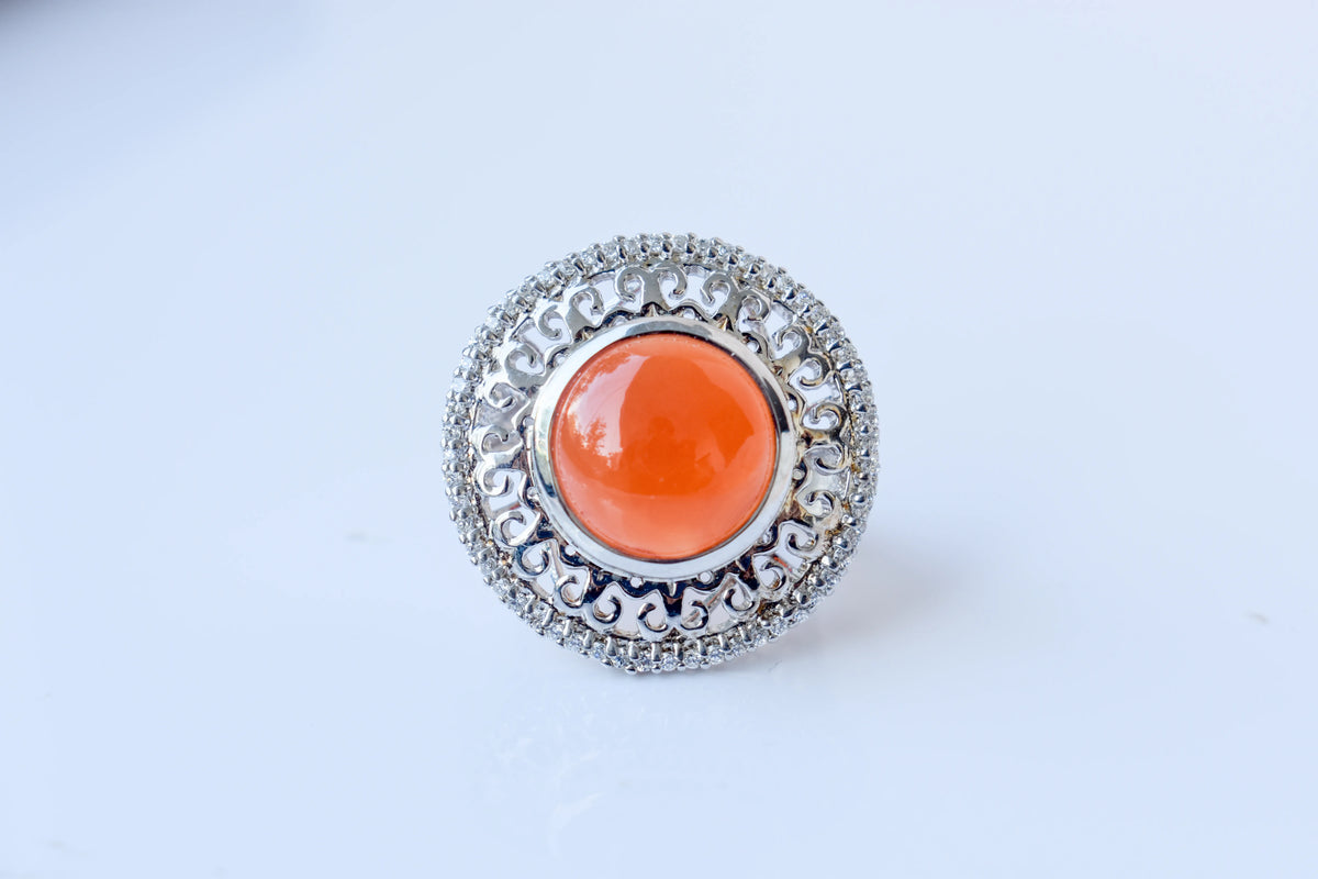 Orange cabochon gemstone ring in 925 silver with ornate scrollwork setting