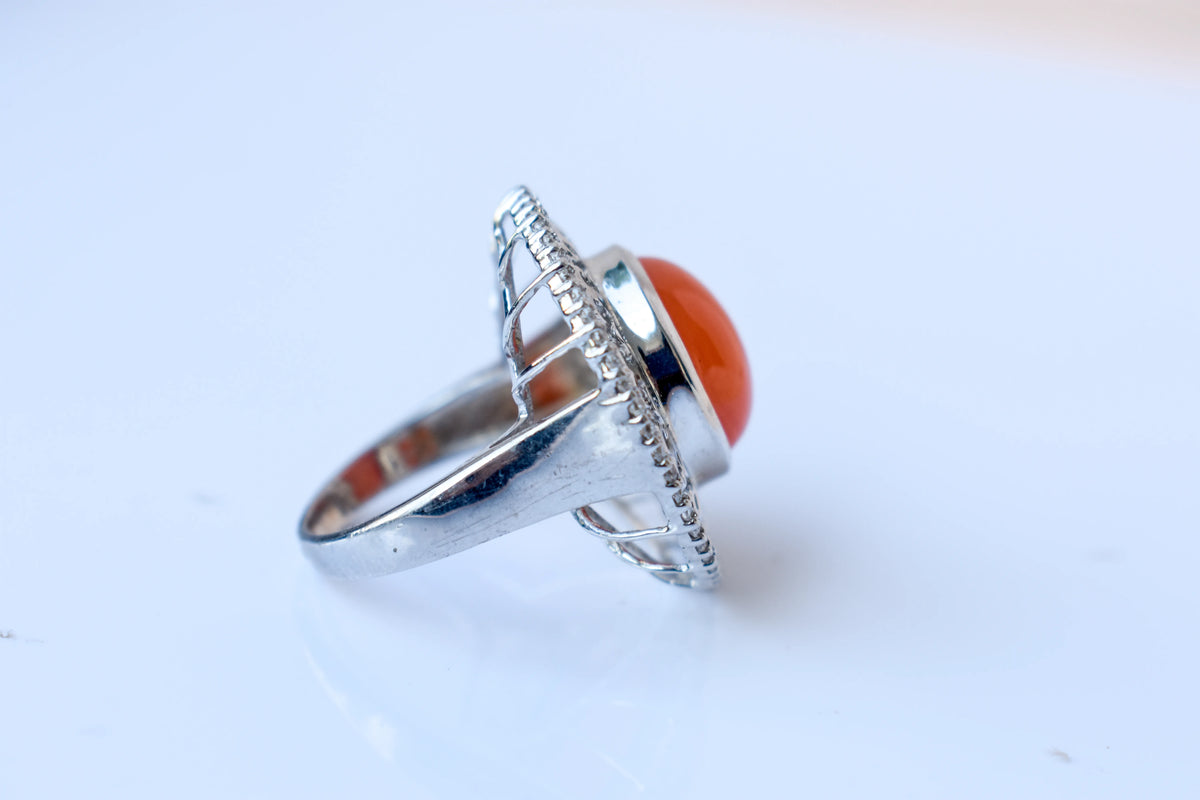 Orange cabochon gemstone ring in 925 silver with ornate scrollwork setting
