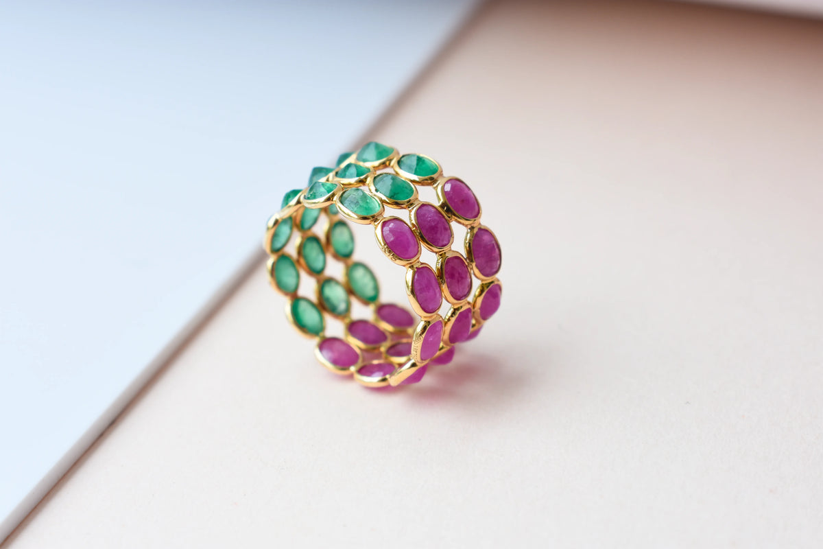 Two-tone emerald and ruby eternity ring in 18K gold