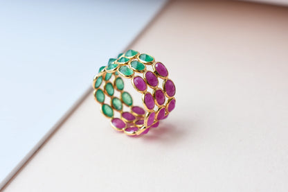 Two-tone emerald and ruby eternity ring in 18K gold