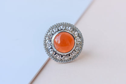 Orange cabochon gemstone ring in 925 silver with ornate scrollwork setting