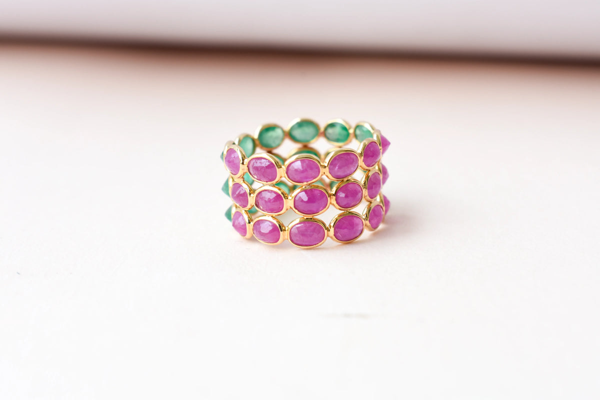 Two-tone emerald and ruby eternity ring in 18K gold