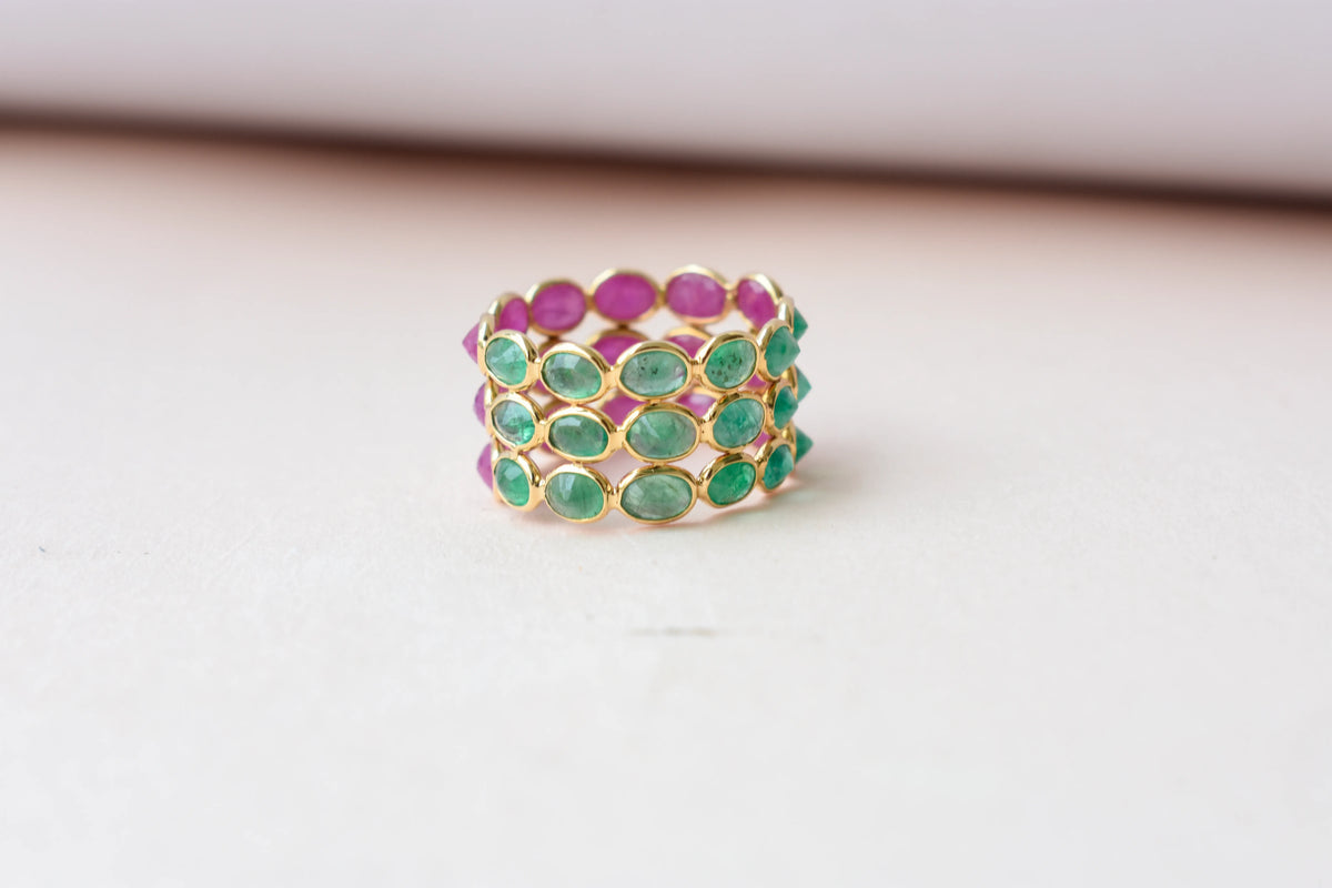 Two-tone emerald and ruby eternity ring in 18K gold