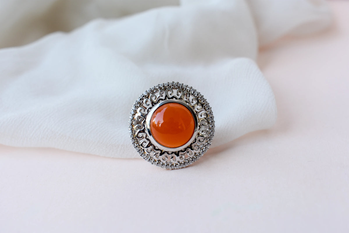 Orange cabochon gemstone ring in 925 silver with ornate scrollwork setting