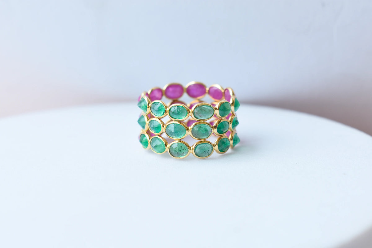 Two-tone emerald and ruby eternity ring in 18K gold