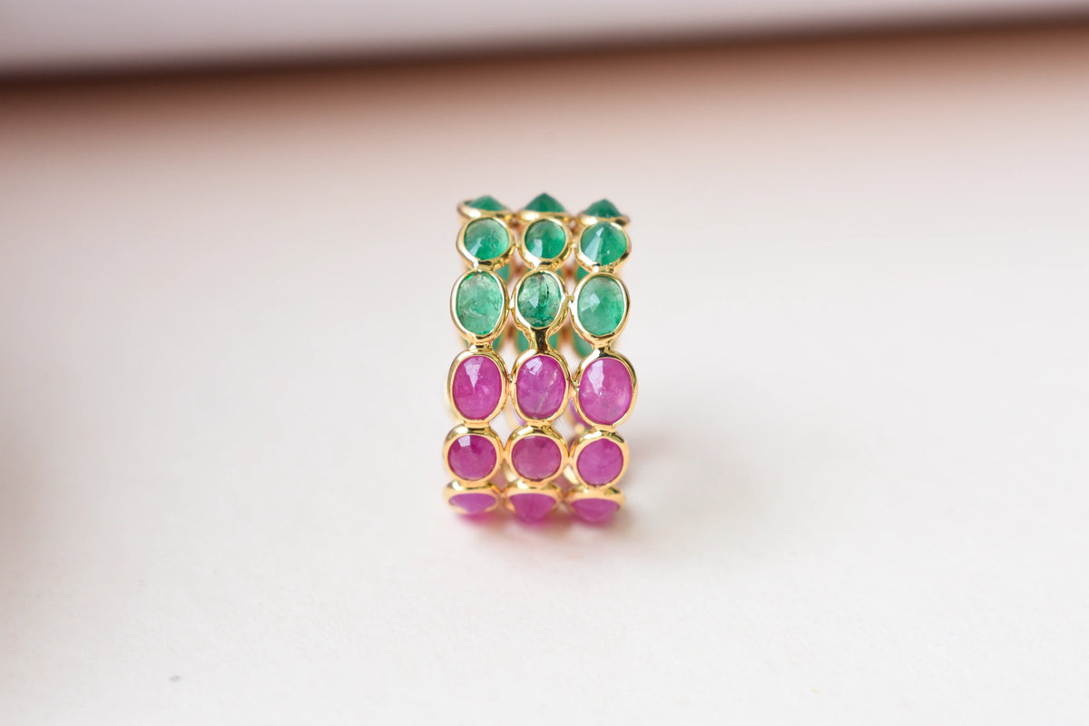 Two-tone emerald and ruby eternity ring in 18K gold