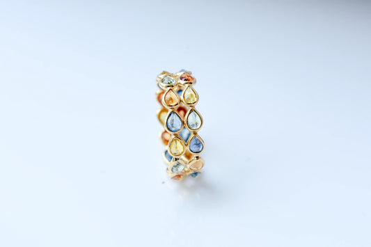 Pear-cut multicolor sapphire woven eternity ring in 18K gold, blue tones