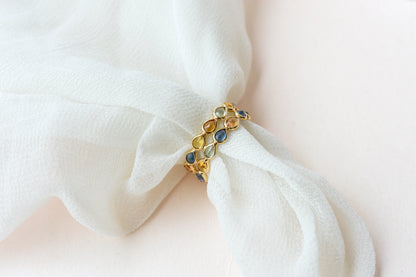 Pear-cut multicolor sapphire woven eternity ring in 18K gold, blue tones