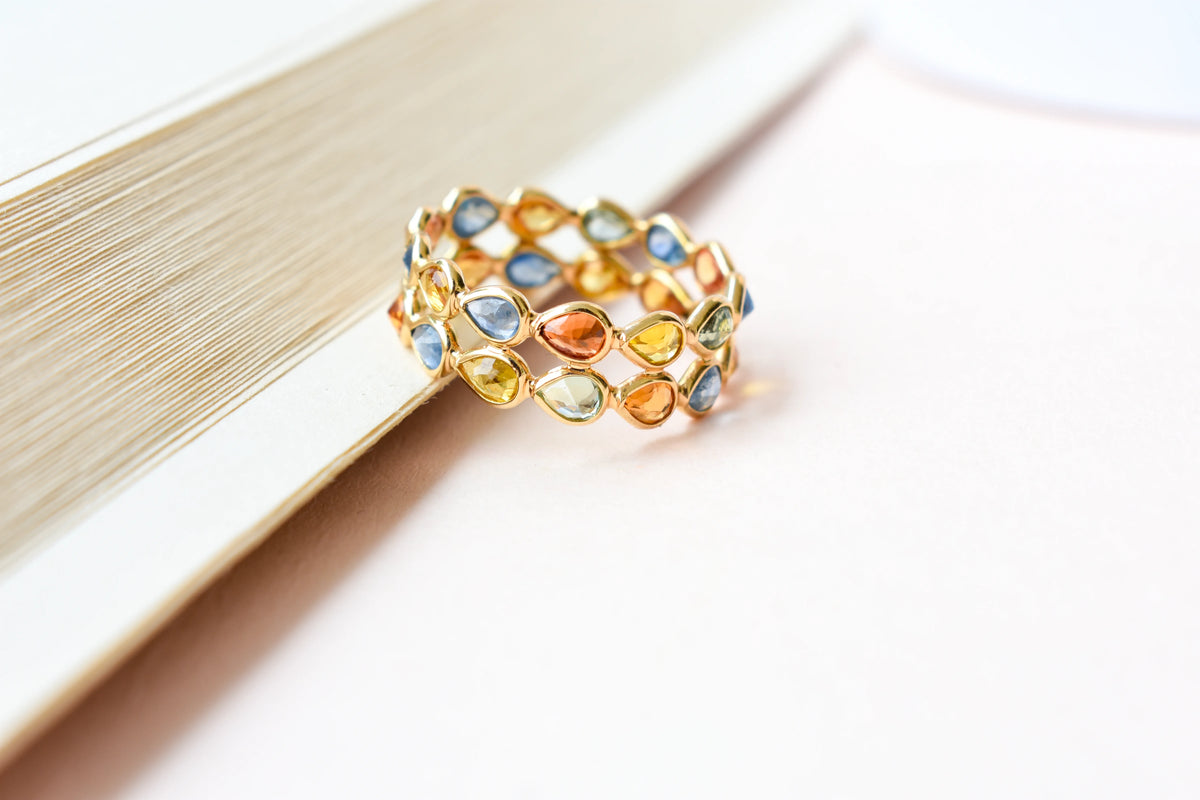Pear-cut multicolor sapphire woven eternity ring in 18K gold, blue tones