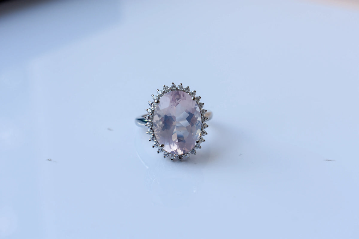 Oval rose quartz halo ring in 925 silver with cubic zirconia accents