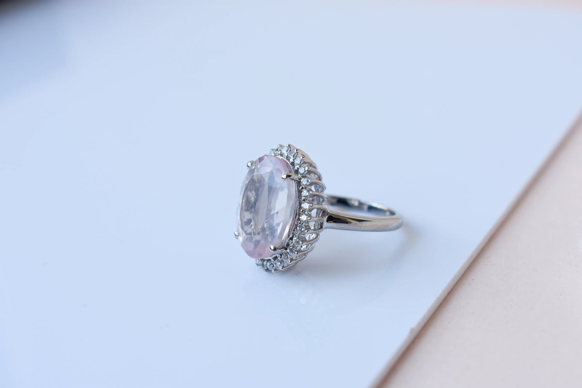 Oval rose quartz halo ring in 925 silver with cubic zirconia accents