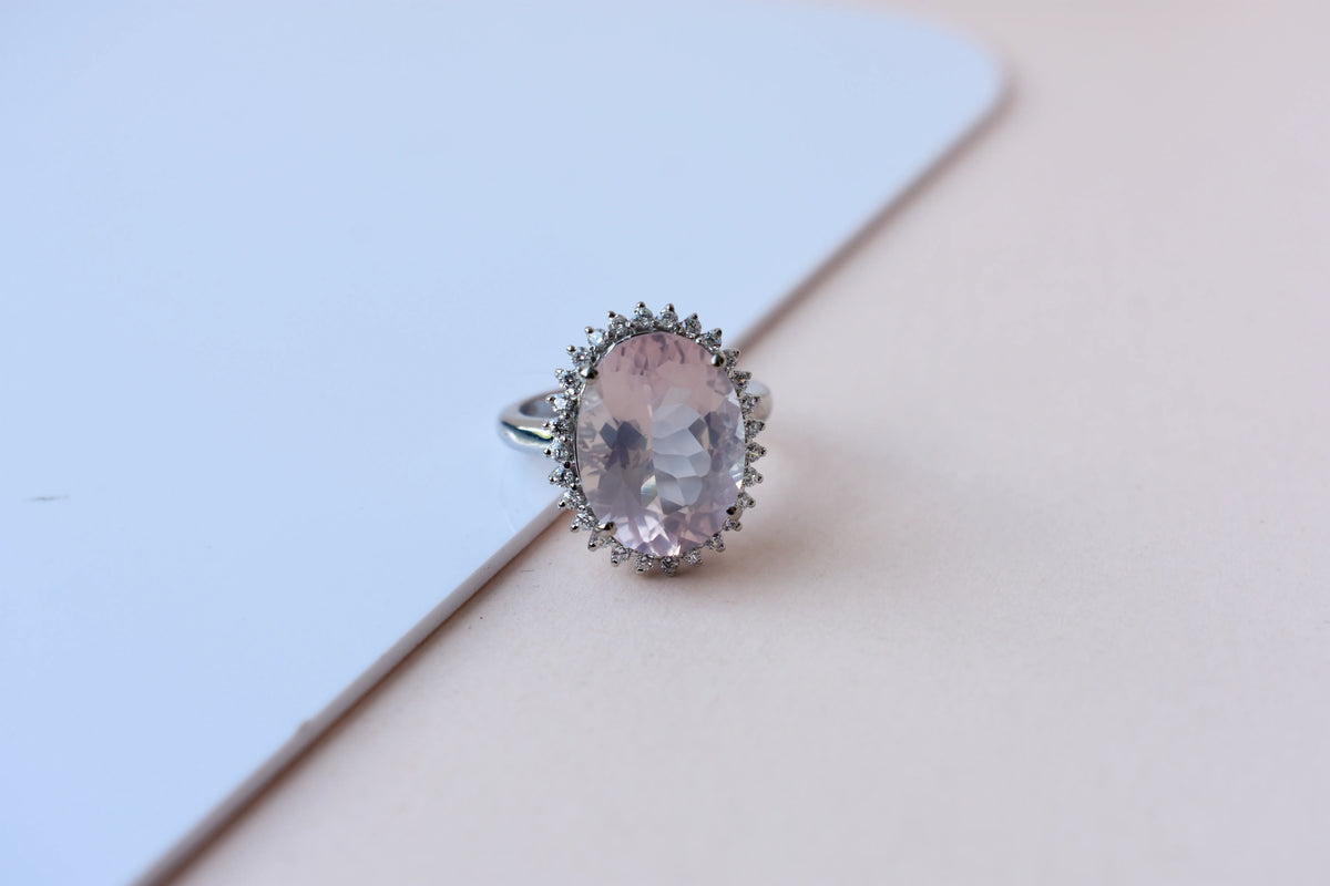Oval rose quartz halo ring in 925 silver with cubic zirconia accents
