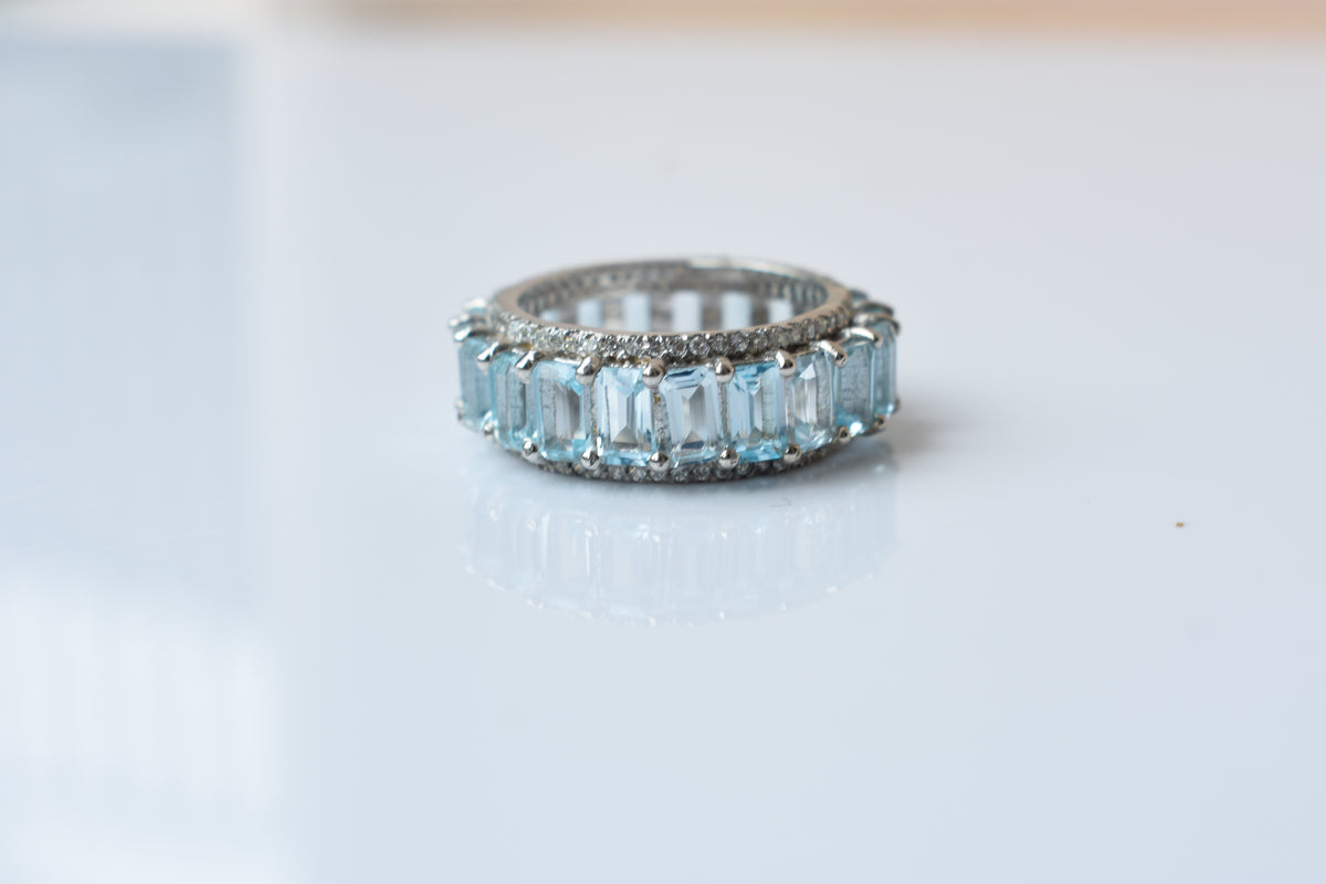 Sky blue topaz emerald-cut eternity ring in 925 silver